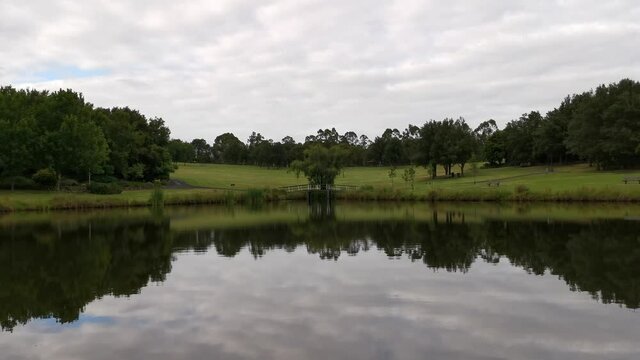 Beautiful video of a pond with stunning reflections of trees and clouds on water, Fagan Park, Dural, Sydney, New South Wales, Australia
