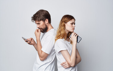 young couple with phone in hands technology communication lifestyle emotions friendship