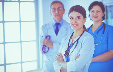 Group of doctors and nurses standing in a hospital room