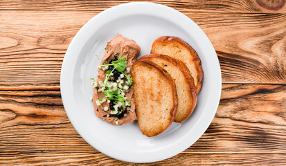 Delicious chicken, duck, or rabbit liver pate or foie gras with spices. fried toast and pate with microgreens