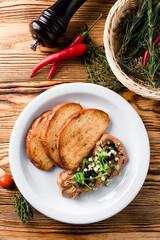 Delicious chicken, duck, or rabbit liver pate or foie gras with spices. fried toast and pate with microgreens © smspsy