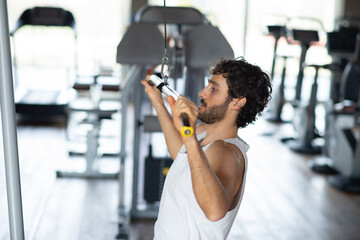 Man training shoulders in a gym