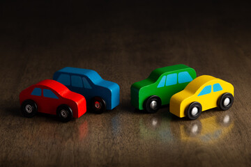 Obraz na płótnie Canvas Wooden toy cars that are red, blue, green, and yellow.