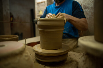 Fototapeta na wymiar Handmade clay pot made by hand on manual lathe
