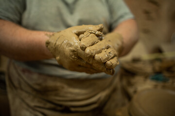 hands full of clay potter craft