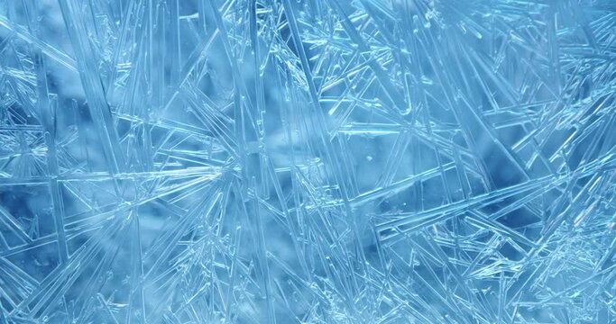 Frost covered window with lights shimmering and glittering over ice crystals.