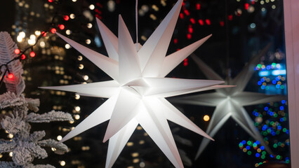 Christmas Lights And Star on the window. Festive christmas and new year decorations