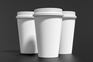 Three white take away coffee paper cups mock up with white lids on black background.