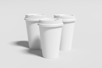 Three white take away coffee paper cups mock up with white lids on white background.