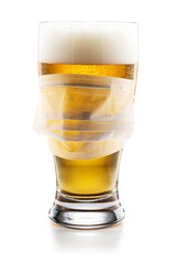Surgical Mask on a Beer Glass Isolated on White Background, COVID-19 Social Distancing Concept