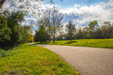 Augusta Canal Trail empty paved trail with Fall foliage along side of a road