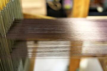 Kyoto,Japan-November 22, 2020: Closeup of Nishijin-ori silk yarns. Number of yarns are 2,400.

