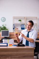 Young male employee working in the office