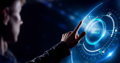 Business, Technology, Internet and network concept. Young businessman working on a virtual screen of the future and sees the inscription: 2021 goals