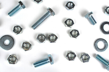 group of bolts and nuts made of metal on a white background