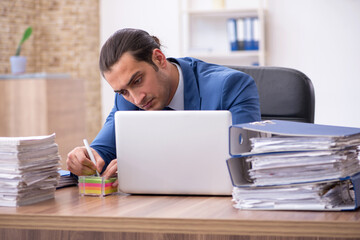 Young male employee unhappy with excessive work