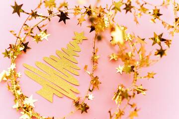 Golden and white glitter decoration and pink background.