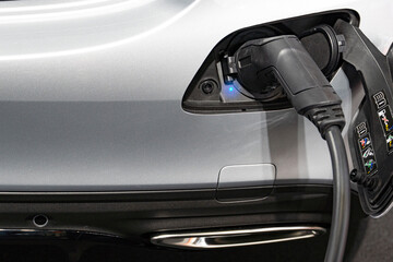 Obraz na płótnie Canvas E-power car concept, car electric power charging, EV car concept, technology power of the car, close up EV charging.