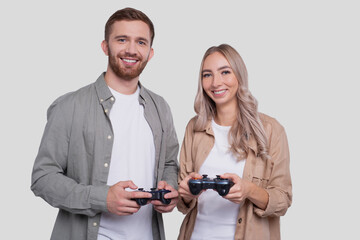 Couple Standing with Joysticks in Hands Smilling Isolated