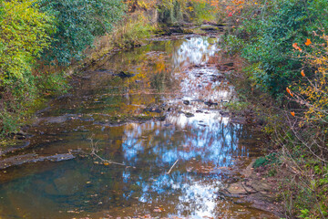Augusta Canal Trail a colorful Fall river and concrete wall