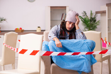 Young man suffering at home in pandemic concept