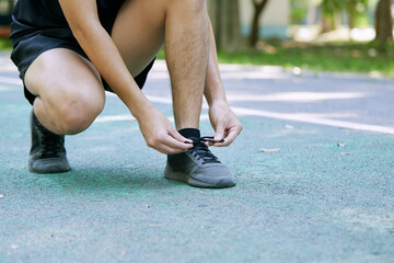 Man Tying Shoelace Before Jogging