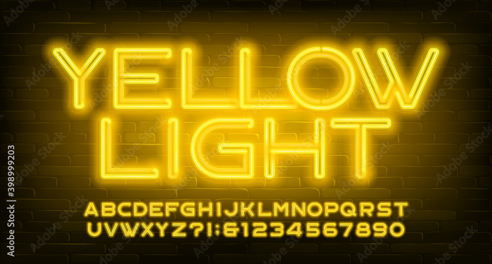 Fototapete yellow light alphabet font. neon light letters and numbers. brick wall background. stock vector type