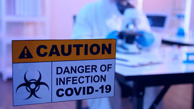 Scientist in PPE suit conducts research on the COVID 19 vaccine at a laboratory. - Powered by Adobe