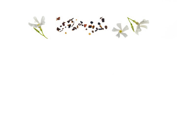 closeup of loose tea and jasmine flowers in bloom with copy space below
