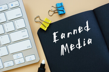 Business concept about Earned Media with sign on the piece of paper.