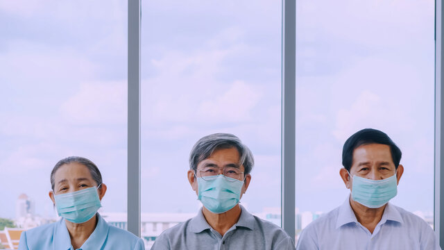 Group Of Senior Wearing Protective Face Masks During Quarantine At Home.