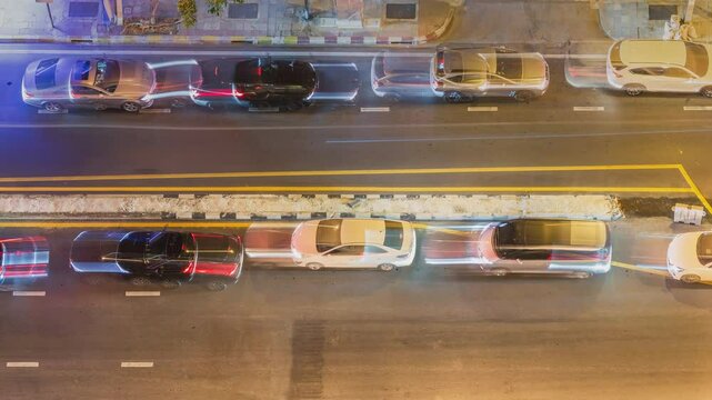 Footage 4k Timelapse, Overhead view of the road traffic jam at a highway junction, top-down View of a freeway car stop and moving slowly on the road busy city rush hour heavy traffic jam in a night.
