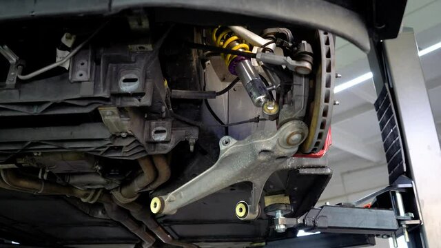 Disassembled car suspension, lever unscrewed