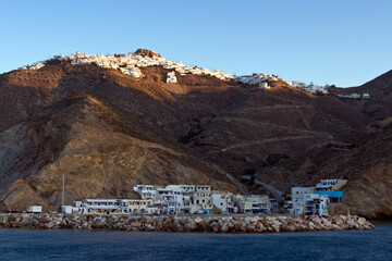 Fototapeta na wymiar Anafi island, sunrise at Chora village and the port. Aegean sea, Cyclades islands, Greece 