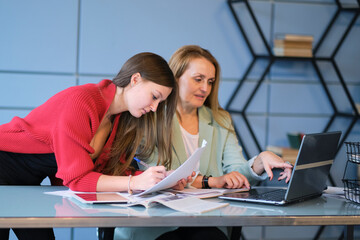 senior mentor a colleague teaches a junior employee. Office. Concept of work.