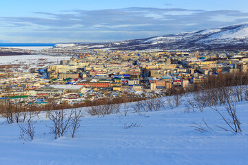 Winter cityscape. Top view of the northern city. The city of Magadan is located among the mountains on the coast of the Sea of ​​Okhotsk. The administrative center of the Magadan Region, Russia.