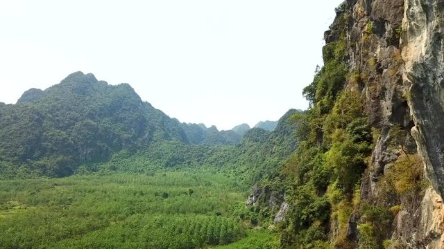 Drone shot of limestone mountain in Quang Binh Province near Dong Hoi, Vietnam, Southeast Asia with mountains in the background. Scene of remote, unpopulated Vietnam scenery.