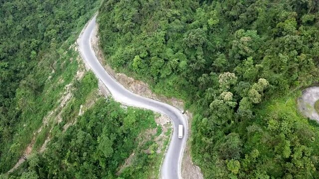 Drone shot of hairpins and winding road in the countryside surrounded by forest and jungle at Ma Pi Leng Pass, Vietnam, Southeast Asia.