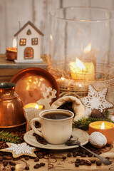 Cup of coffee and jute sack with raw grains on the table.