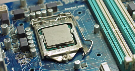 The repairman cleans the CPU of the laptop from the old thermal grease. Electronics and computer concepts service. Repair of computer boards