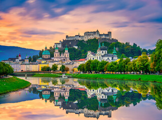 Salzburg sunrise skyline with Festung Hohensalzburg fortress and reflection. Austria