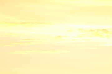 Sun below the horizon and clouds in the fiery dramatic orange sky at sunset or dawn backlit by the sun. Place for text and design