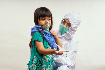 Nurse in protective suit takes care of the patient child in hospital Quarantine room