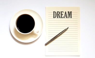 DREAM - white paper with pen and coffee on white background