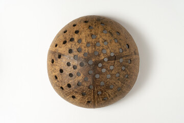 A filter made of coconut shell. Used to make traditional food.