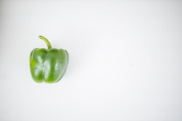 Green bell pepper isolated on a white table