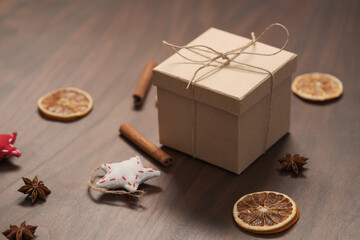 Christmas gift box from eco friendly paper wrapped with natural twine on wood table with natural decorations