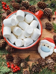 Santa in a mask gingerbread and a big red creative cup