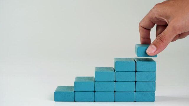Business growth, building success, ladder career path foundation concept, Hand arranging wooden block stacking as step stair. Copy space.
