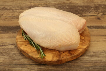 Raw whole chicken breast with skin